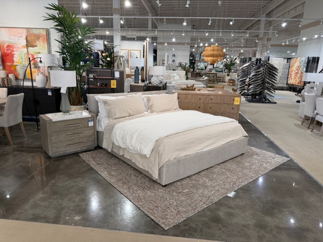 Clean modern light uhpolostered bedframe in showroom